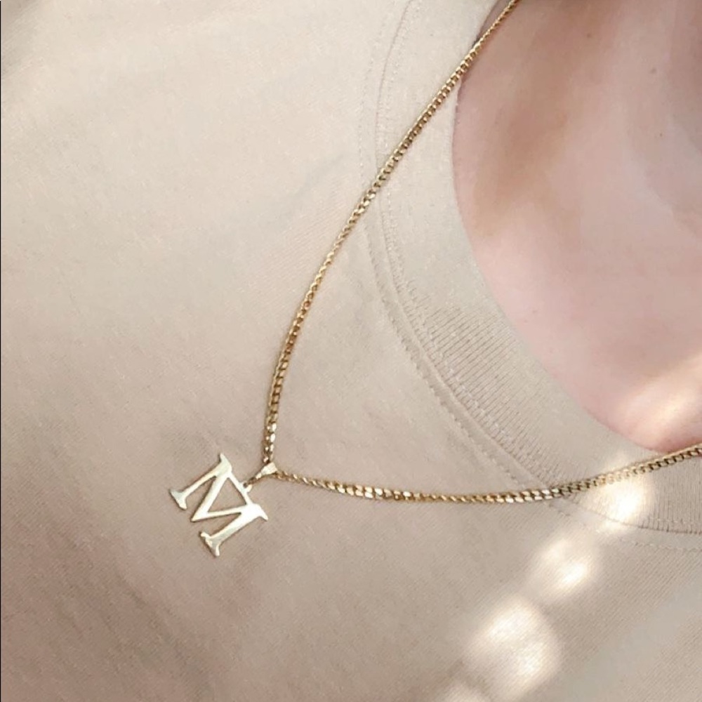 Customized “M” gold chain from The M Jewelers